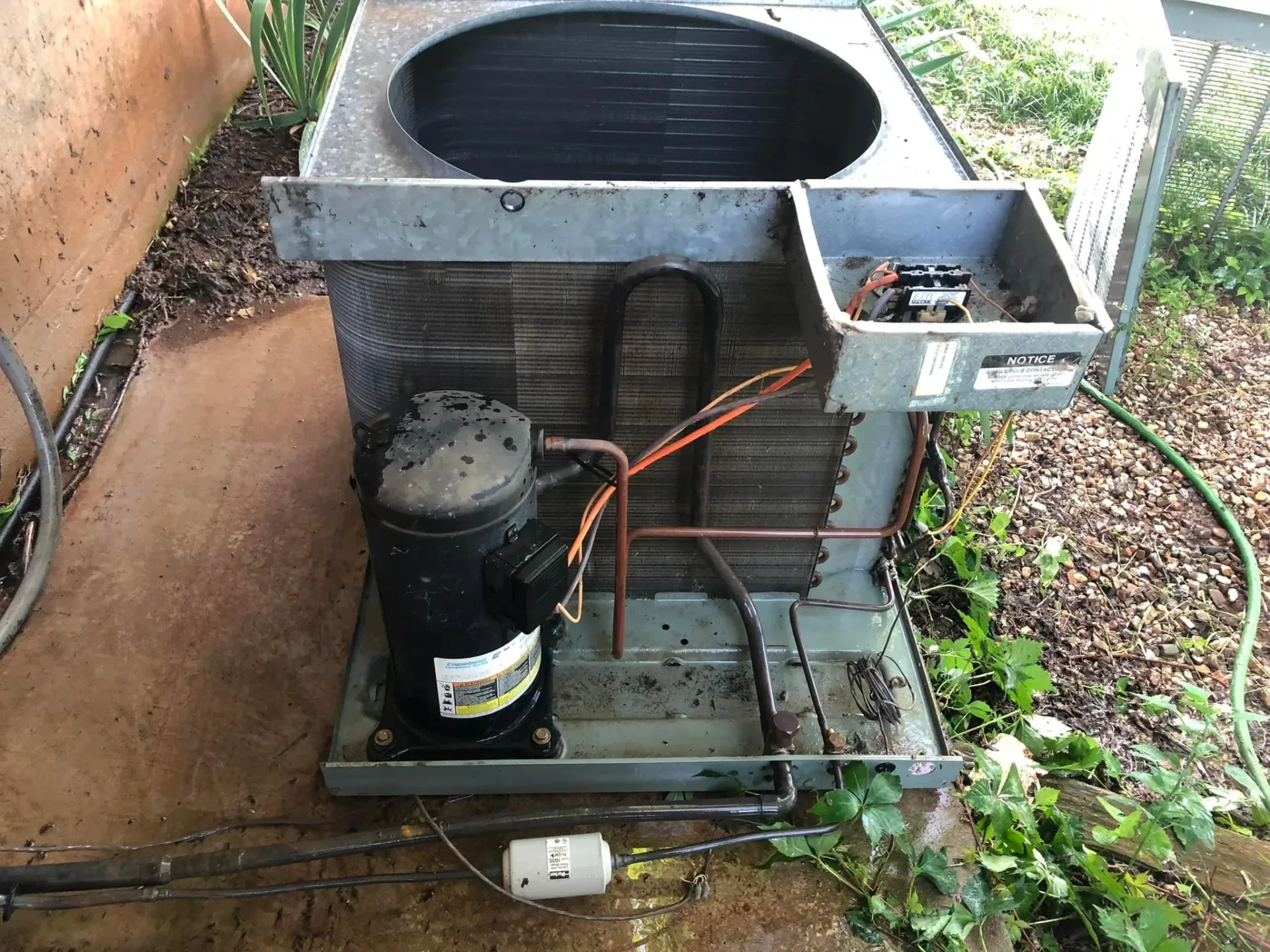 AC condenser unit internal components being serviced