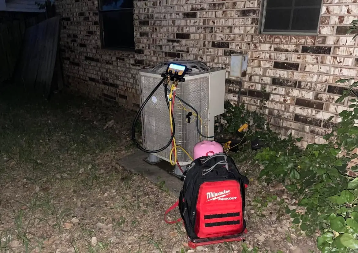 HVAC unit connected to diagnostic gauges during AC repair