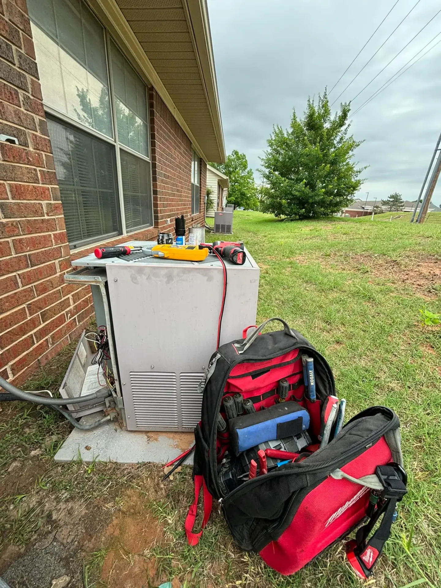 AC outdoor unit with repair tools in Perkins Oklahoma