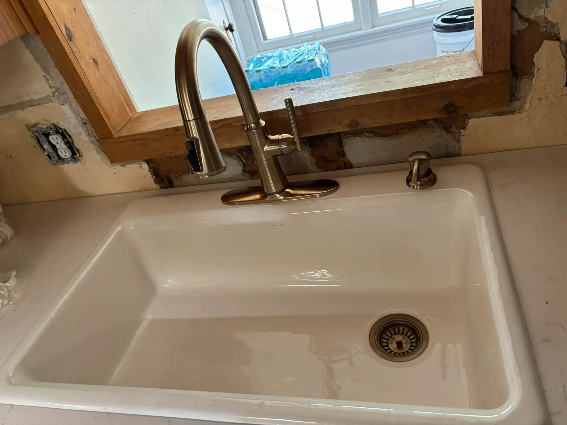 New Kohler sink with bronze faucet installed by Full Send