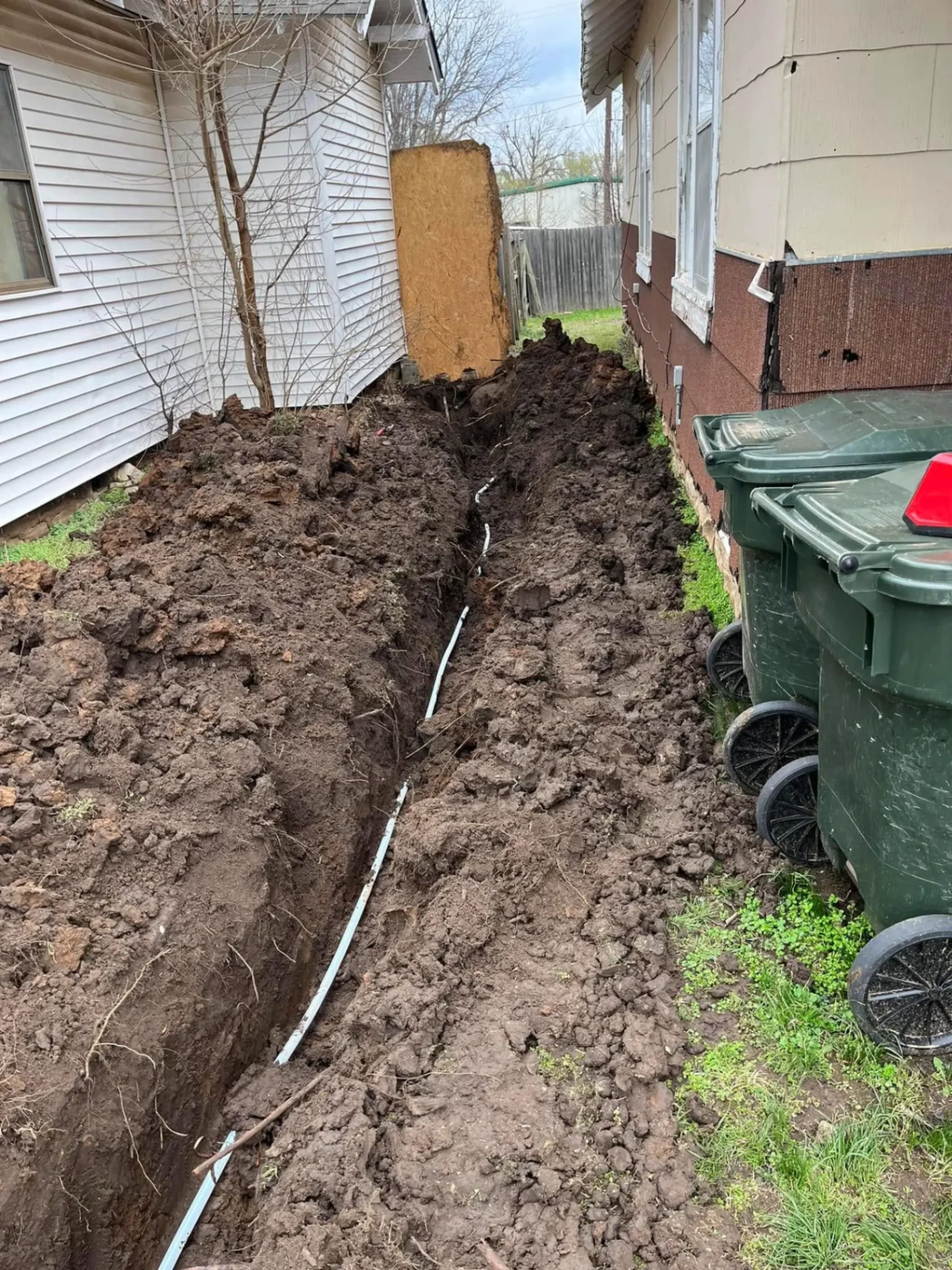 Underground pipe trench dug for plumbing repair